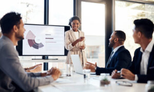 businesswoman delivering a presentation to her colleagues