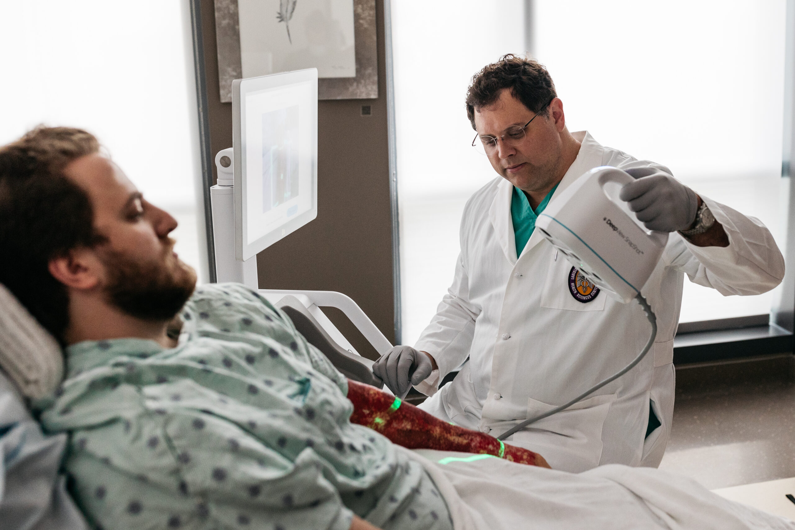 Doctor using DeepView device on a patient's wound evaluation