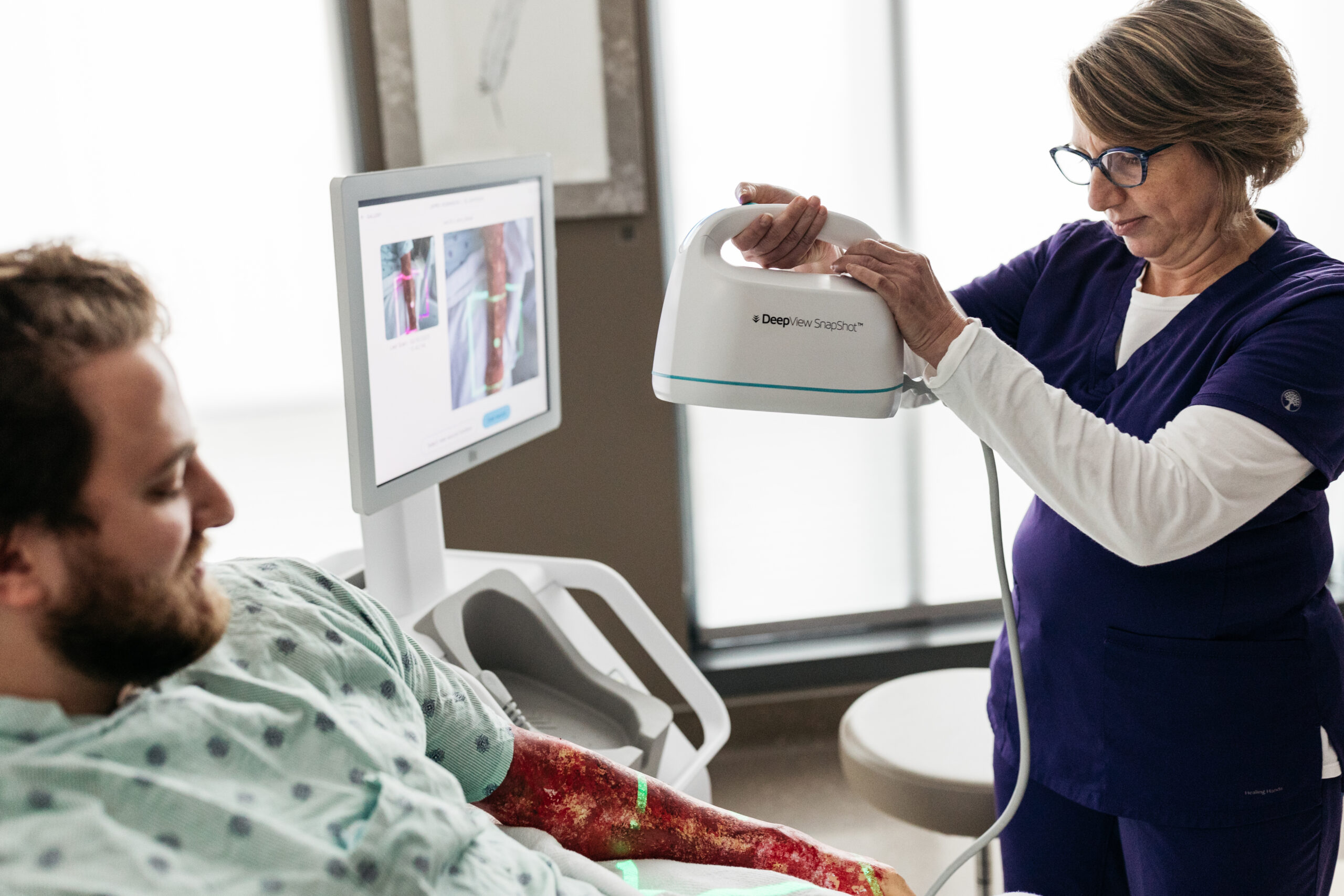 Nurse using DeepView device on patient